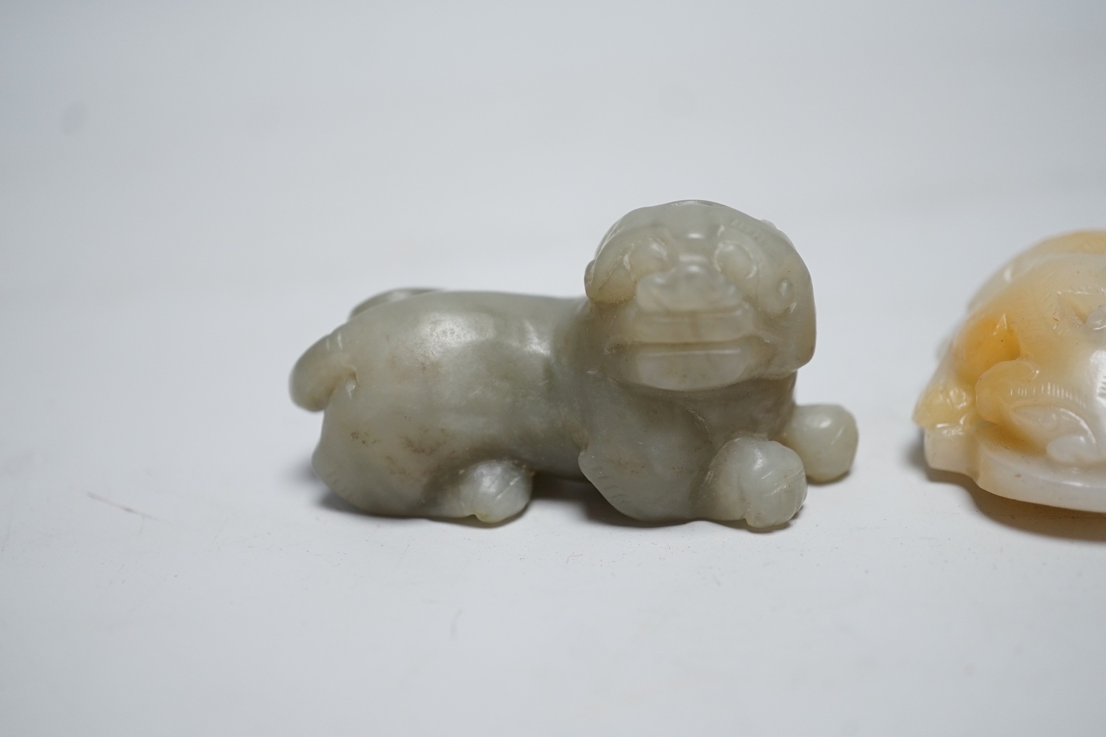 A Chinese white and russet Jade chilong carving and a celadon jade figure of a lion-dog, 7cm